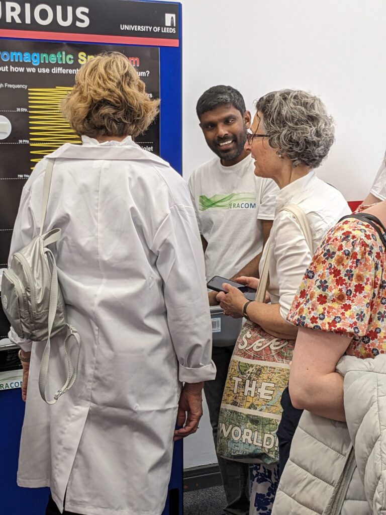 Researcher talks to members of the public about the electromagnetic spectrum at Be Curious 2024