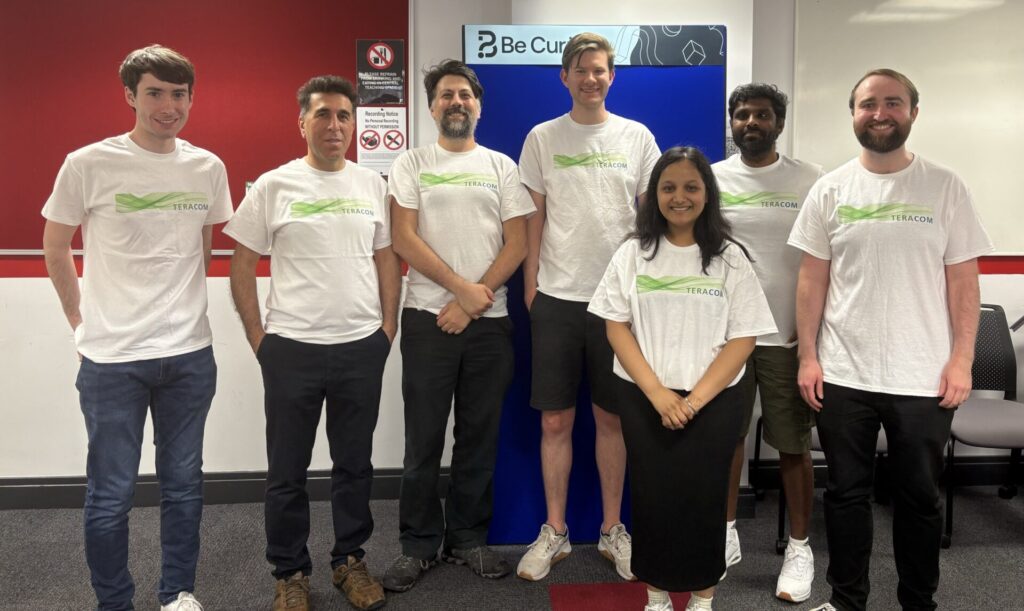 TeraCom students, postdocs, and researchers, wearing matching TeraCom t-shirts, after a long day at Be Curious 2025.