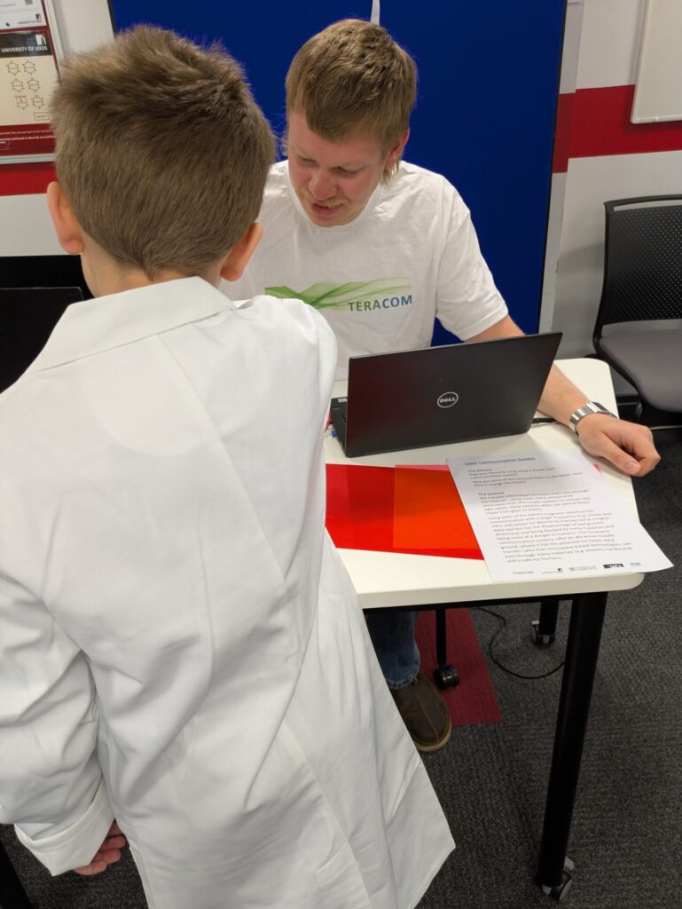 Nathan showing a child the laser comms demo.