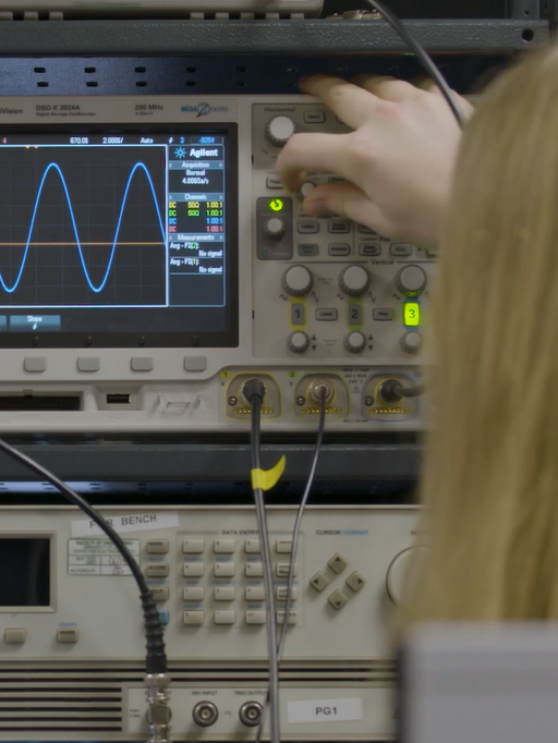 Researcher altering instrumentation in the lab.